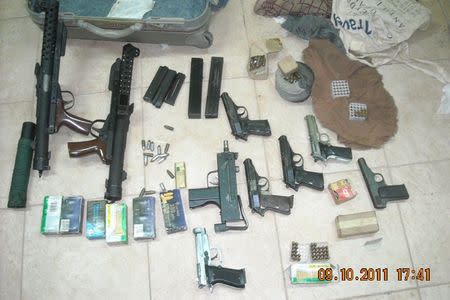 Weapons seized by Cape Verde's judicial police during their raid on targets involved in the Flying Boat case are seen on display in Praia, Cape Verde, in this October 9, 2011 handout. REUTERS/Cape Verde Judicial Police/Handout via Reuters/Files