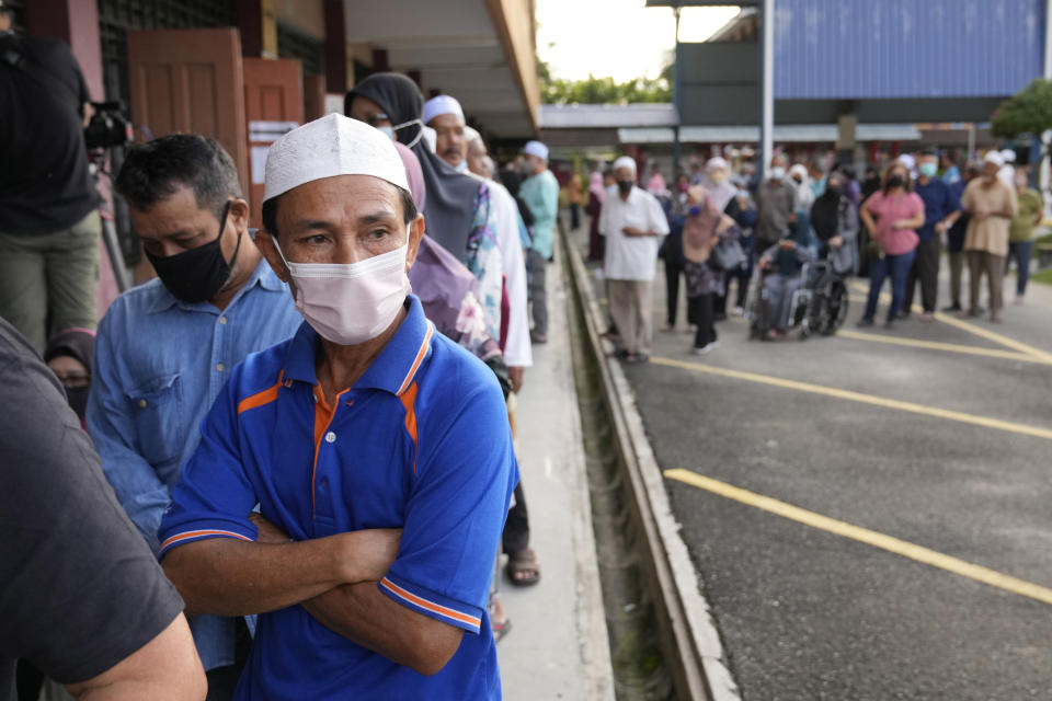 People queue up to cast their ballot during the election at a polling station in Seberang Perai, Penang state, Malaysia, Saturday, Nov. 19, 2022. Malaysians began casting ballots Saturday in a tightly contested national election that will determine whether the country's longest-ruling coalition can make a comeback after its electoral defeat four years ago. (AP Photo/Vincent Thian)