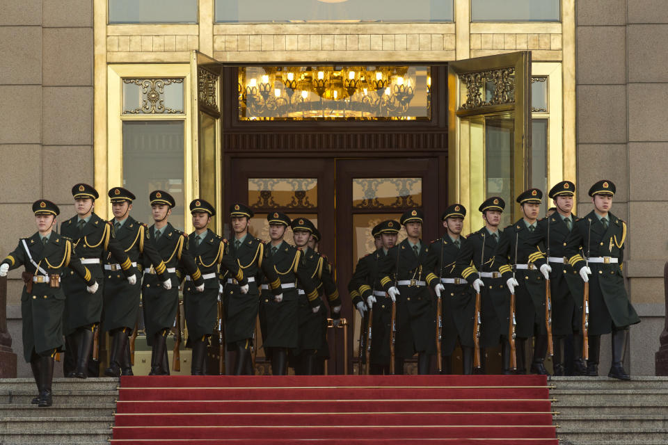 Soldiers march out of the Great Hall of the People to their positions before a welcome ceremony held by Chinese President Xi Jinping for visiting Pakistani President Mamnoon Hussain in Beijing Wednesday, Feb. 19, 2014. (AP Photo/Alexander F. Yuan, Pool)