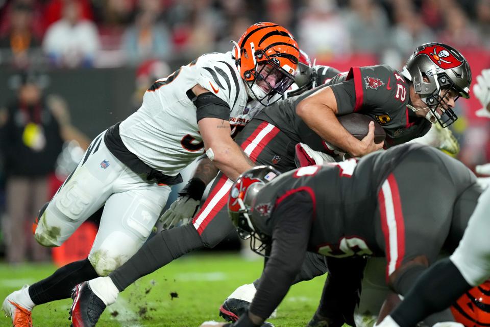 Cincinnati Bengals linebacker Logan Wilson (55) sacks Tampa Bay Buccaneers quarterback Tom Brady (12) in the third quarter during a Week 15 NFL game, Sunday, Dec. 18, 2022, at Raymond James Stadium in Tampa, Fla. The Cincinnati Bengals won, 34-23. The Cincinnati Bengals improved to 10-4 on the season. 