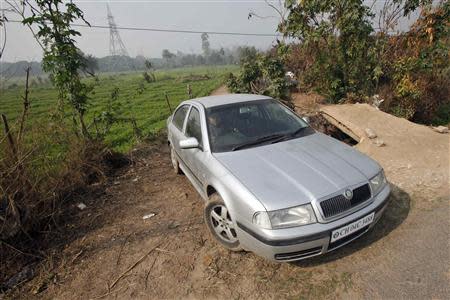 A villager drives a Skoda Octavia car through fields in Kishangarh village on the outskirts of the northern Indian city of Chandigarh January 31, 2014. REUTERS/Ajay Verma