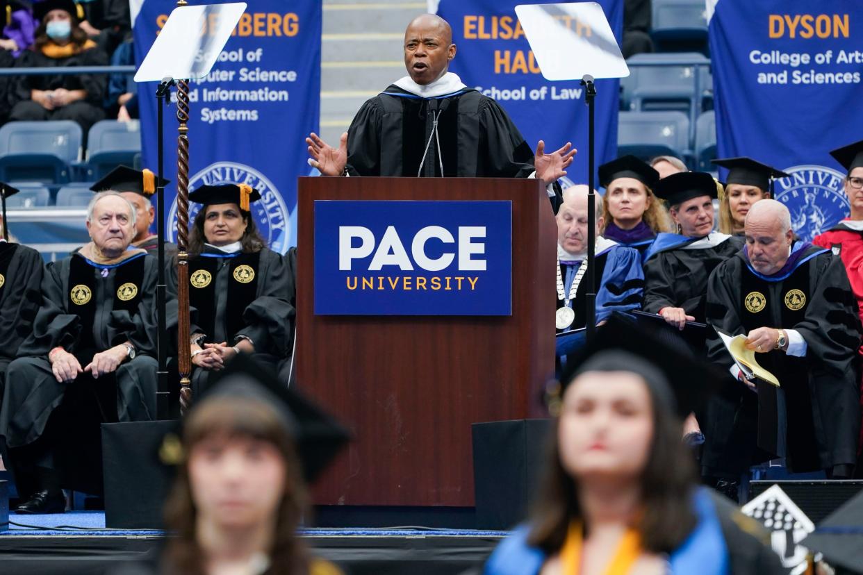 New York City Mayor Eric Adams speaks as some graduates turn their back to him in protest during a graduation ceremony for Pace University at the USTA Billie Jean King Tennis Center in Flushing, Queens, New York on Monday, May 16, 2022. 