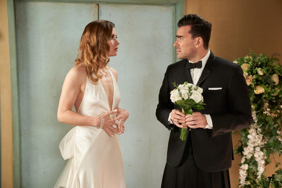 Ew, David! Is Alexis (Annie Murphy) wearing a wedding gown to walk her brother (Dan Levy) down the aisle?