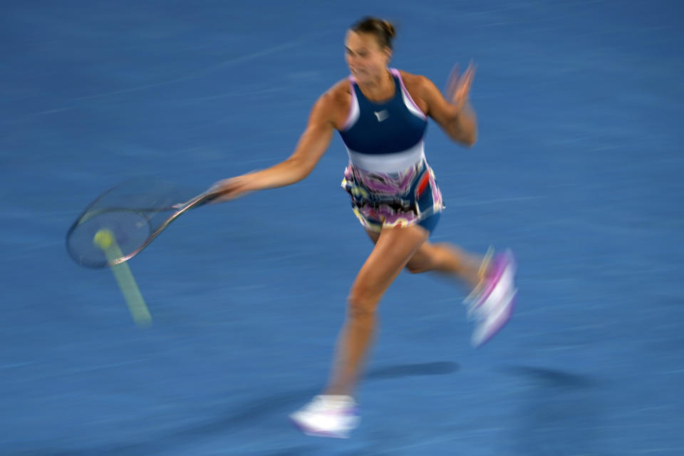 Aryna Sabalenka of Belarus plays a forehand return to Magda Linette of Poland during their semifinal match at the Australian Open tennis championship in Melbourne, Australia, Thursday, Jan. 26, 2023. (AP Photo/Ng Han Guan)