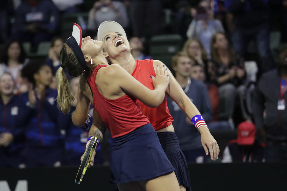 United States' Bethanie Mattek-Sands, right, and Sofia Kenin look to the replay screen to confirm their victory over Latvia's Jelena Ostapenko and Anastasija Sevastova during the doubles match in a Fed Cup tennis qualifying tie, Saturday, Feb. 8, 2020, in Everett, Wash. The U.S. team won the doubles match, and the U.S. advanced in the tourney. (AP Photo/Elaine Thompson)