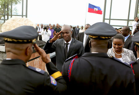 Haiti's President President Jovenel Moise (C) and first lady Martine Moise (R) greet attendees during an event in commemoration of the eighth anniversary and day of remembrance for the people killed on the island by a devastating earthquake, in Port-au-Prince, Haiti January 12, 2018. REUTERS/Jeanty Junior Augustin