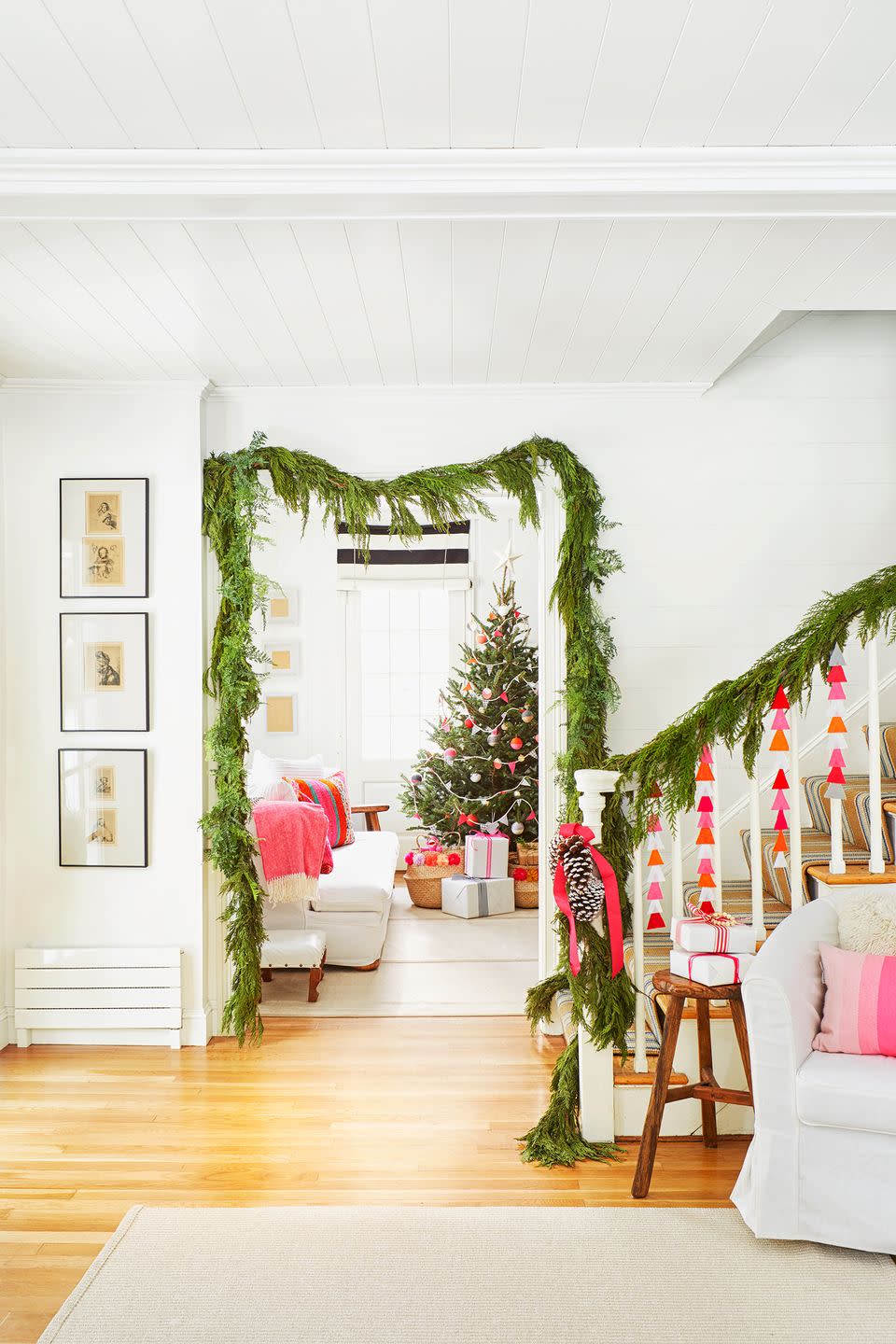 <p>Grab some construction paper in fun, vibrant colors, and then cut out some shapes. Glue them together and hang them from your garland to give it a fresh, personal touch. To make it all match, tie a ribbon in a corresponding color around the end of the banister. </p>