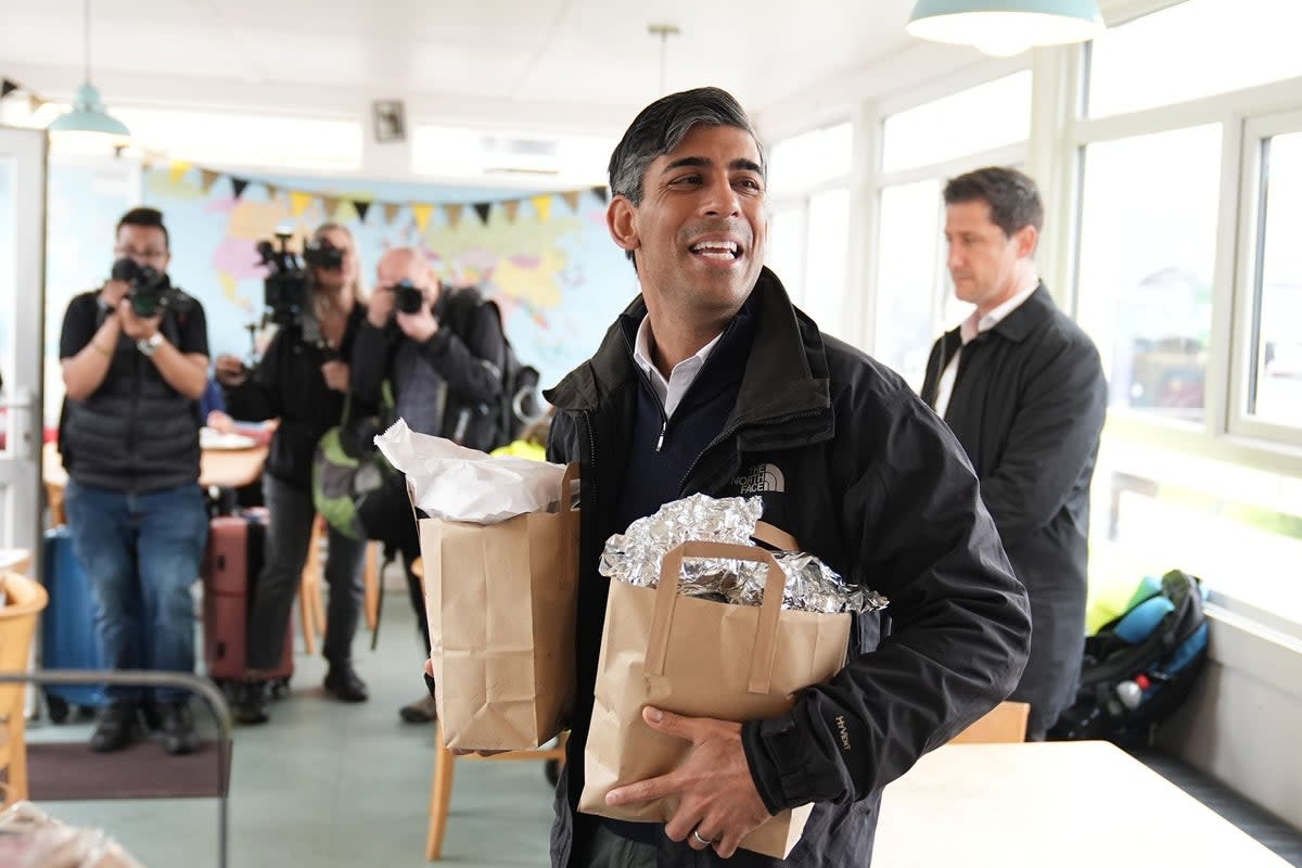 The PM handed out bacon and sausage butties after taking the sleeper train to an election campaign stop in Cornwall (Aaron Chown/PA Wire)