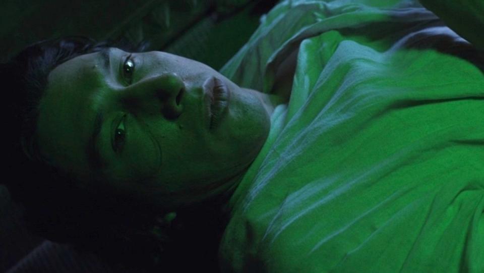 Ben Solo lying down bathed in thegreen light of Luke's lightsaber in The Last Jedi