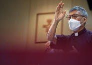 Stephen Chow Sau-yan prays after a press conference in Hong Kong Tuesday, May 18, 2021. Pope Francis on Monday named a new bishop for Hong Kong, tapping the head of his own Jesuit order in the region, the Rev. P. Stephen Chow Sau-Yan, for the politically sensitive position that has been vacant for two years. (AP Photo/Vincent Yu)