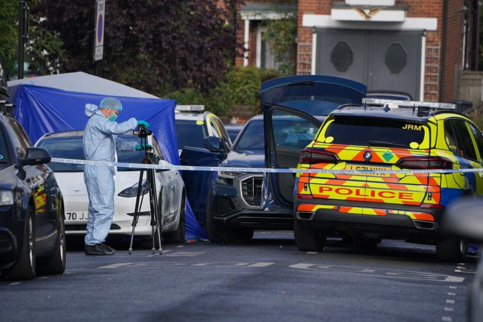 A forensic scientist at the crime scene in Kirkstall Gardens, Streatham Hill, south London (PA)