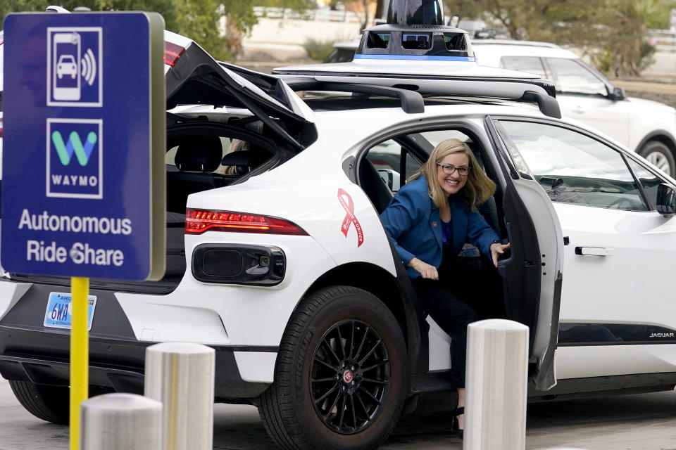 FILE - Phoenix Mayor Kate Gallego arrives in a Waymo self-driving vehicle on Dec. 16, 2022, at the Sky Harbor International Airport Sky Train facility in Phoenix. Self-driving car pioneer Waymo announced Thursday, May 4, 2023, that its robotaxis will be able to carry passengers through most of the Phoenix area for the first time. (AP Photo/Matt York, File)