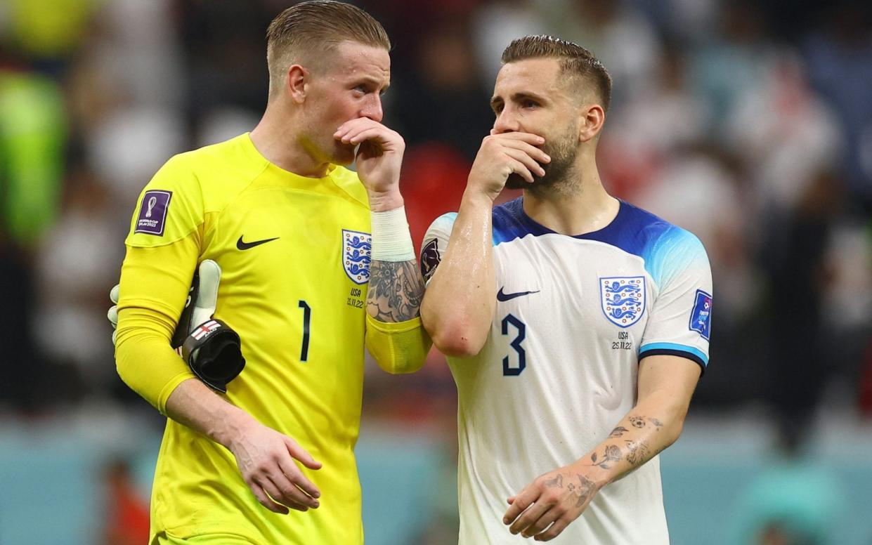 England's Luke Shaw and Jordan Pickford cover their mouths as they chat - Reuters