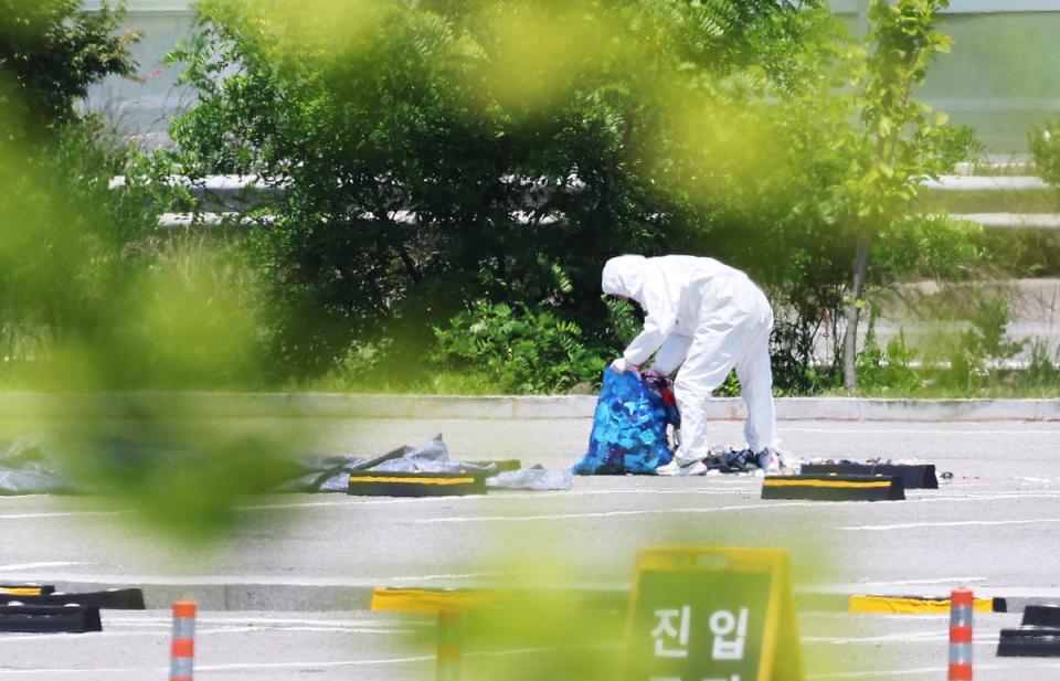 An official collects the debris of a balloon sent by North Korea at a shopping centre in Siheung, west of Seoul, on Sunday (EPA)