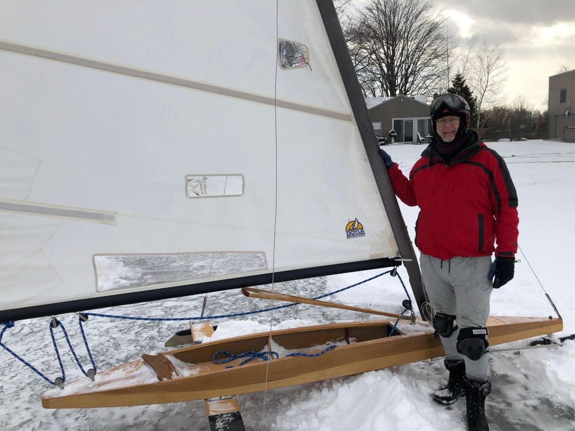 Christopher Cole with the hand-crafted, DN-class ice boat he ordered 25 years ago. (Darrin Di Carlo/CBC - image credit)