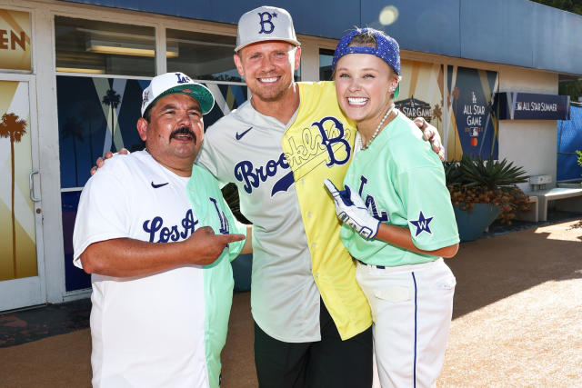 JoJo Siwa of Team Finch high-fives teammates after the MLB All