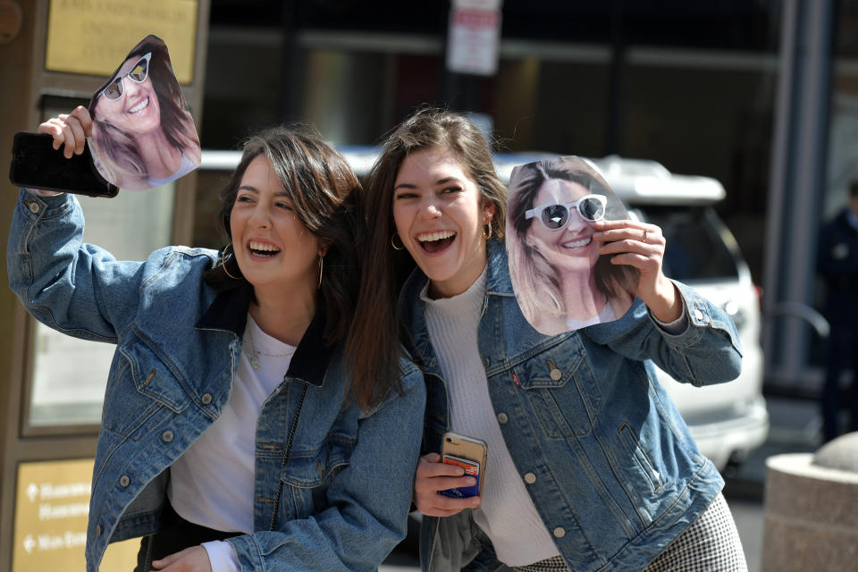 Fans of Lori Loughlin hold photo masks of Loughlin before she enters the John Joseph Moakley U.S. Courthouse after appearing in Federal Court to answer charges stemming from college admissions scandal on April 3, 2019 in Boston, Massachusetts.