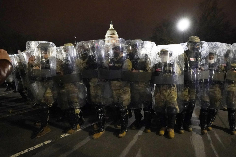DC National Guard stand outside the Capitol, Wednesday, Jan. 6, 2021, after a day of rioting protesters. (AP Photo/Julio Cortez)