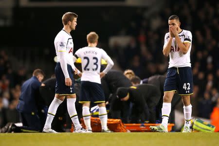 Football - Tottenham Hotspur v Swansea City - Barclays Premier League - White Hart Lane - 4/3/15 Swansea's Bafetimbi Gomis is stretchered off with an injury as Nabil Bentaleb and team mates look on Action Images via Reuters / John Sibley Livepic EDITORIAL USE ONLY. No use with unauthorized audio, video, data, fixture lists, club/league logos or "live" services. Online in-match use limited to 45 images, no video emulation. No use in betting, games or single club/league/player publications. Please contact your account representative for further details.