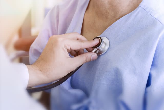 <p> </p><p>Anchalee Phanmaha / Getty Images</p> Stock image of a doctor checking patient's heart with stethoscope at a hospital