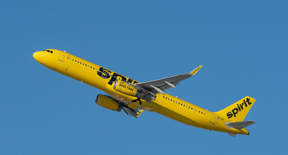 Spirit Airlines plane flies through the sky.