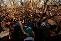 People gather around the body of Zahoor Ahmad, a suspected militant, who according to local media reports was killed during a gun battle with Indian soldiers, during his funeral in Sirnoo village in south Kashmir's Pulwama district December 15, 2018. REUTERS/Danish Ismail