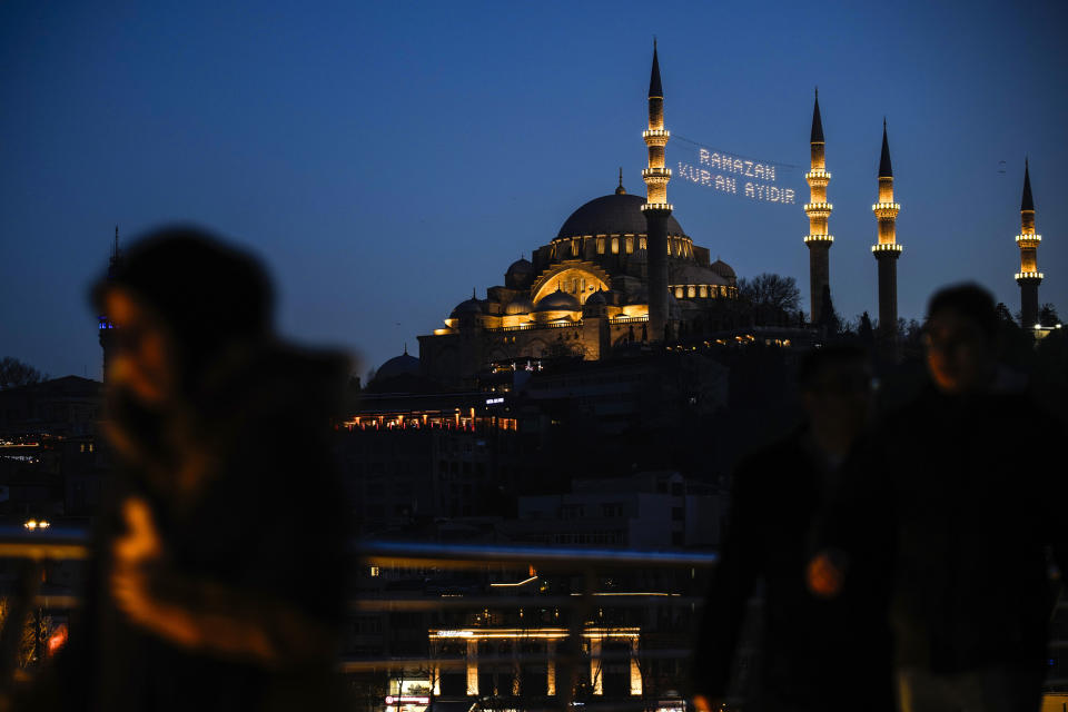 Lights message installed in between the minarets of the Suleymaniye mosque reads in Turkish "Ramadan is the month of Quran" ahead of the Muslim holy month of Ramadan in Istanbul, Turkey, Sunday, March 10, 2024. (AP Photo/Emrah Gurel)