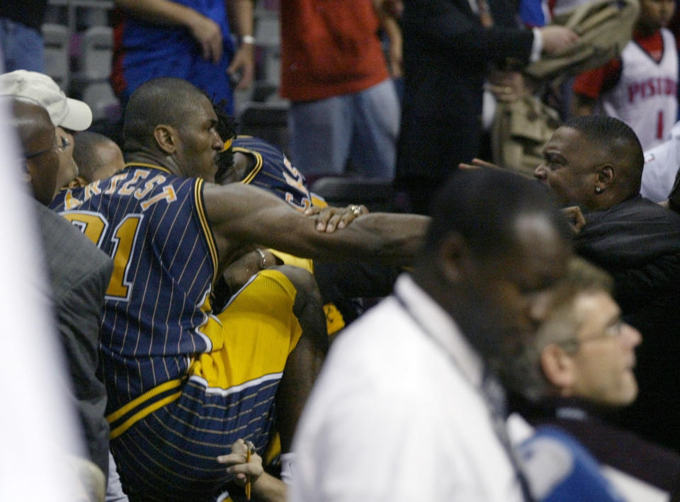 Pacers forward Ron Artest gets into the stands to fight with some fans on Nov. 19, 2004. (AP Photo/Duane Burleson)