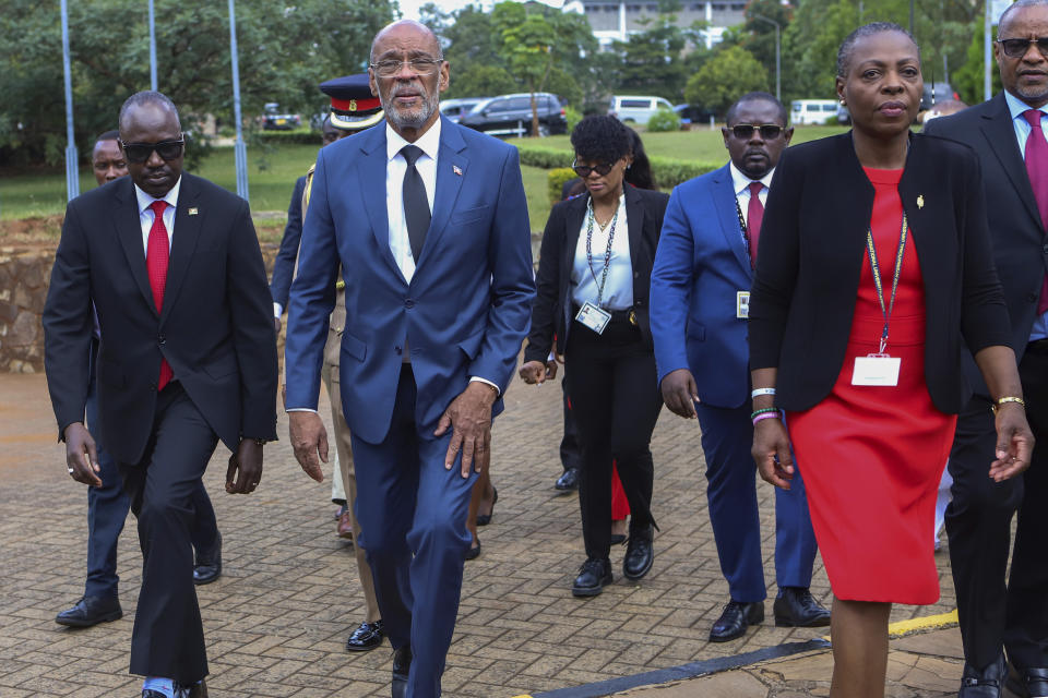 Haiti's Prime Minister Ariel Henry, second left, arrives to give a public lecture at the United States International University (USIU) in Nairobi, Kenya, Friday March. 1, 2024. Haitian Prime Minister Ariel Henry said Friday elections in his country need to be held as soon as possible in order to bring stability to the troubled Caribbean nation facing gang violence that threatens to overran government. Henry is in Kenya trying to salvage the deployment of a foreign armed force to Haiti to help combat gangs. (AP Photo/Andrew Kasuku)