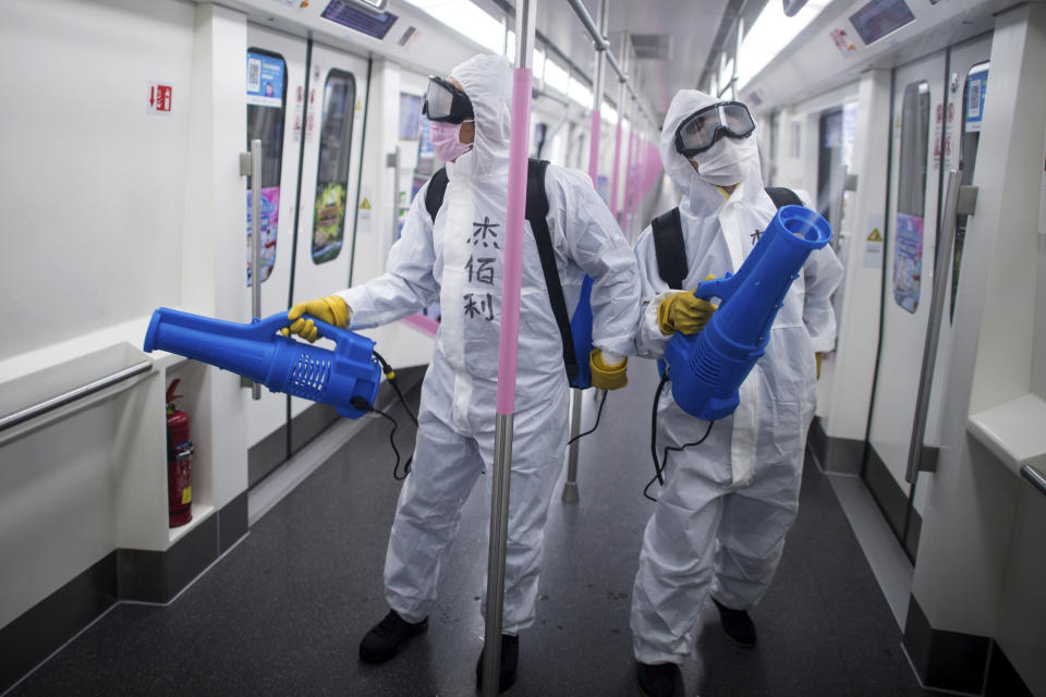 In this March 23, 2020 photo released by Xinhua News Agency, workers disinfect a subway train in preparation for the restoration of public transport in Wuhan, in central China's Hubei province. China's health ministry says Wuhan has now gone several consecutive days without a new infection, showing the effectiveness of draconian travel restrictions that are slowly being relaxed around the country. (Xiao Yijiu/Xinhua via AP)