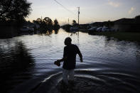 <p>Jean Chatelier walks through a flooded street from Hurricane Irma to retrieve his uniform from his house to return to work today at a supermarket in Fort Myers, Fla., Sept. 12, 2017. Chatelier walked about a mile each way in knee-high water as a Publix supermarket was planning on reopening to the public today. “I want to go back to work. I want to help,” said Chatelier. (Photo: David Goldman/AP) </p>