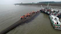 An aerial view shows rescue workers searching on the sunken ship at Jianli section of Yangtze River, Hubei province, China, June 2, 2015. Rescuers fought bad weather on Tuesday as they searched for more than 400 people, many of them elderly Chinese tourists, missing after a cruise boat was buffeted by a freak tornado and capsized on the Yangtze River. (REUTERS/Stringer)