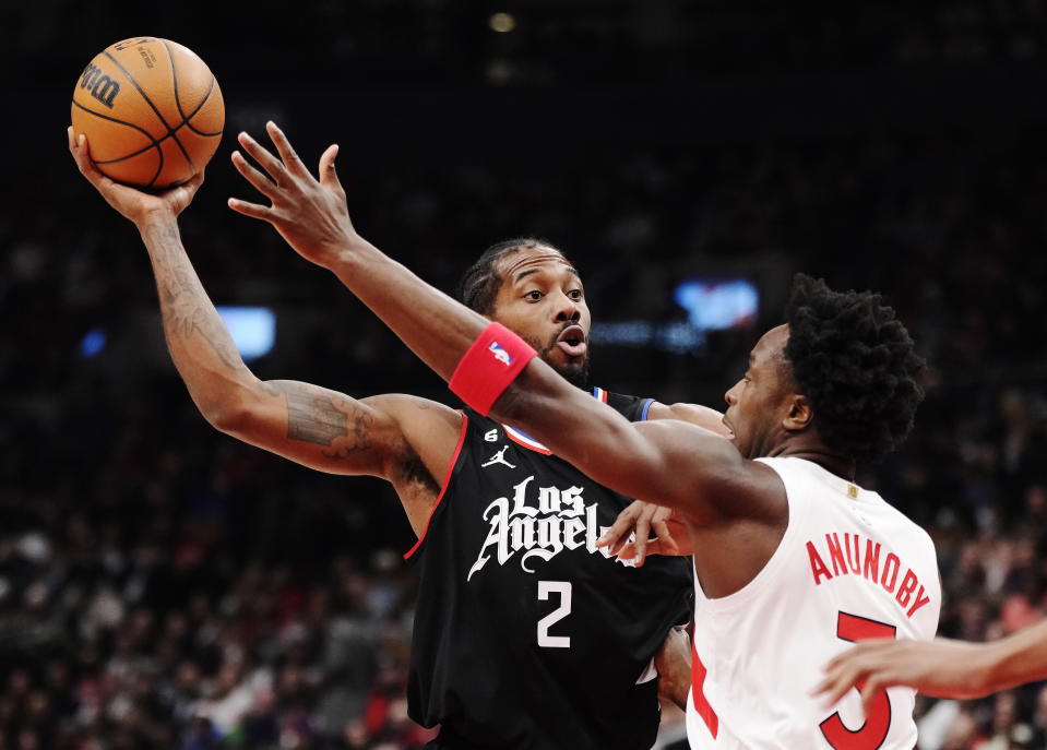 Los Angeles Clippers forward Kawhi Leonard (2) keeps the ball from Toronto Raptors forward O.G. Anunoby (3) during the first half of an NBA basketball game Tuesday, Dec. 27, 2022, in Toronto. (Frank Gunn/The Canadian Press via AP)