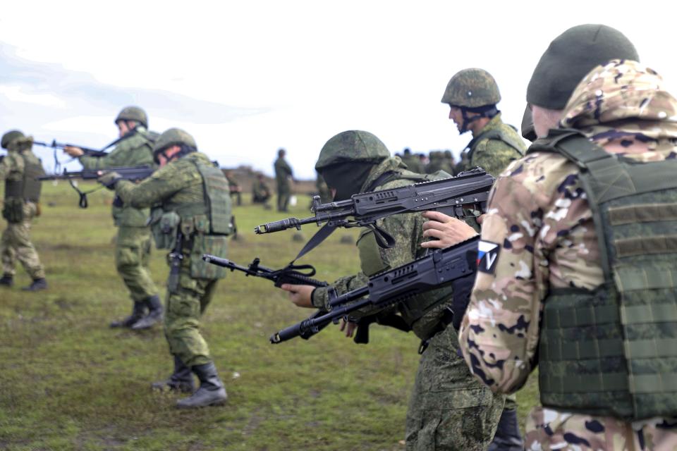 FILE - Recruits hold their weapons during military training at a firing range in the Russian-controlled Donetsk region, eastern Ukraine, Tuesday, Oct. 4, 2022. A campaign to replenish Russian troops in Ukraine with more soldiers appears to be underway again, with makeshift recruitment centers popping up in cities and towns, and state institutions posting ads promising cash bonuses and benefits to entice men to sign contracts enabling them to be sent into the battlefield. (AP Photo, File)