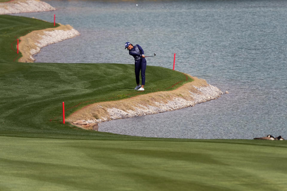 Celine Boutier, of France, hits along the 18th fairway during the first round of the Drive On Championship golf tournament, Thursday, March 23, 2023, in Gold Canyon, Ariz. (AP Photo/Matt York)