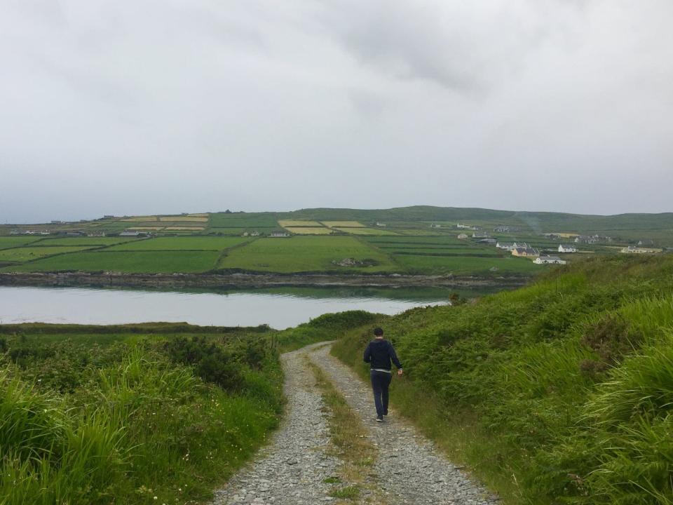 someone walking down a dirt road in rural kerry ireland
