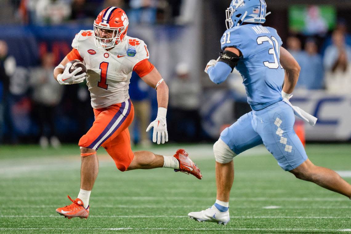 Clemson running back Will Shipley (1) carries while pursued by North Carolina defensive back Will Hardy (31) during the first half of the the Atlantic Coast Conference championship NCAA college football game Saturday, Dec. 3, 2022, in Charlotte, N.C. (AP Photo/Jacob Kupferman) Jacob Kupferman/AP