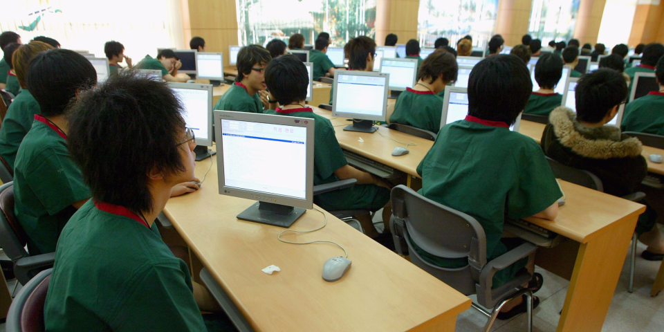 South Korean teenagers sit in a classroom during their physical examination for conscription at the South Korean Military Manpower Administration on January 27, 2005 in Seoul, South Korea. According to the Military Manpower Administration, 310,000 young people join the Armed Forces every year once they have reached the conscription age of 19. (Photo by Chung Sung-Jun/Getty Images)