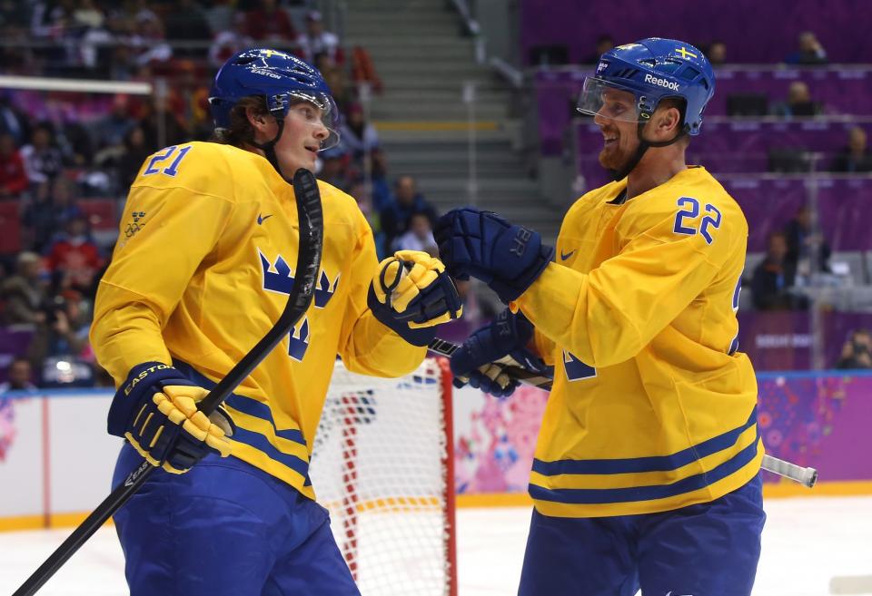  SOCHI, RUSSIA - FEBRUARY 19: Loui Eriksson #21 of Sweden celebrates his goal with Daniel Sedin #22 in the third period against Slovenia during the Men's Ice Hockey Quarterfinal Playoff on Day 12 of the 2014 Sochi Winter Olympics at Bolshoy Ice Dome on February 19, 2014 in Sochi, Russia. (Photo by Bruce Bennett/Getty Images)