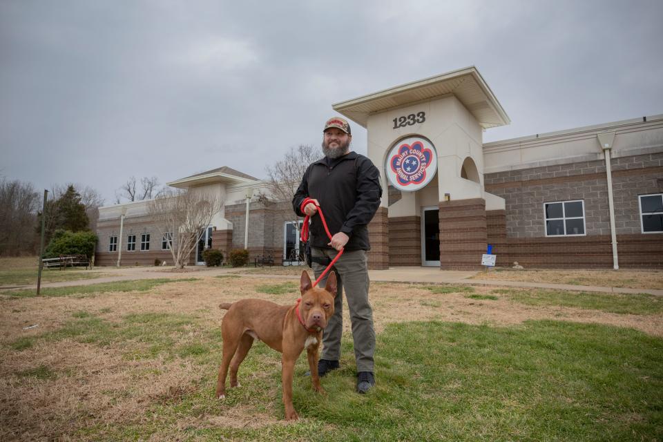 Maury County Animal Shelter Director Jack Cooper stands with a shelter dog named Rebel in the front of the organization’s facility in Columbia, Tenn., on Friday, Jan. 28, 2022.