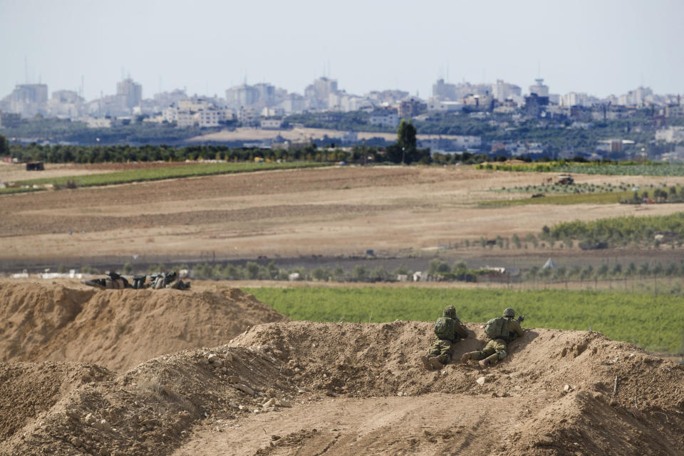 Israeli soldiers observe the Gaza Strip border, Saturday, Oct. 27, 2018. The Israeli military has struck dozens of targets across the Gaza Strip in response to heavy rocket fire and threatened to expand its air campaign to Syria after accusing Iranian forces in Damascus of orchestrating the rocket attacks. (AP Photo/Tsafrir Abayov)