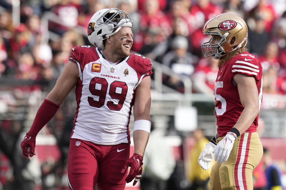 Arizona Cardinals defensive end J.J. Watt (99) smiles while talking with San Francisco 49ers tight end George Kittle during the first half of an NFL football game in Santa Clara, Calif., Sunday, Jan. 8, 2023. (AP Photo/Godofredo A. Vásquez)