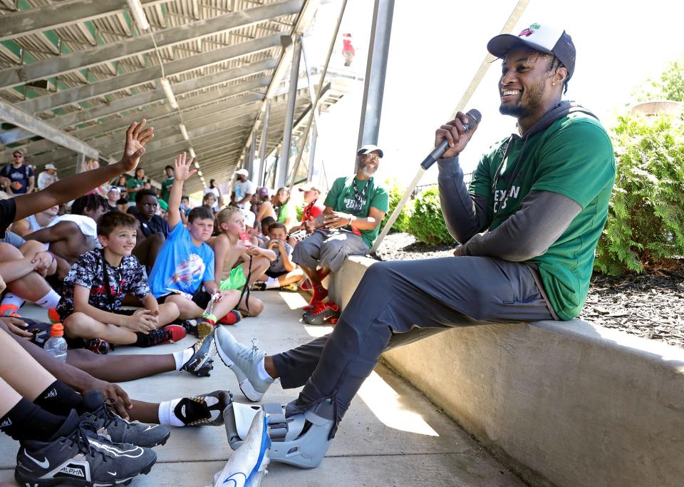 Browns cornerback Denzel Ward laughs as he takes questions from young athletes during a football skills camp at STVM High School on Thursday.