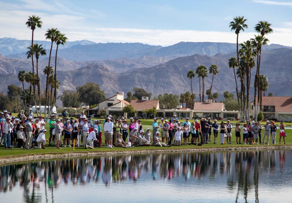 The gallery on the 18th green is brought up to the edge of the water during the final round of the Galleri Classic in Rancho Mirage, Calif., Sunday, March 26, 2023. 
