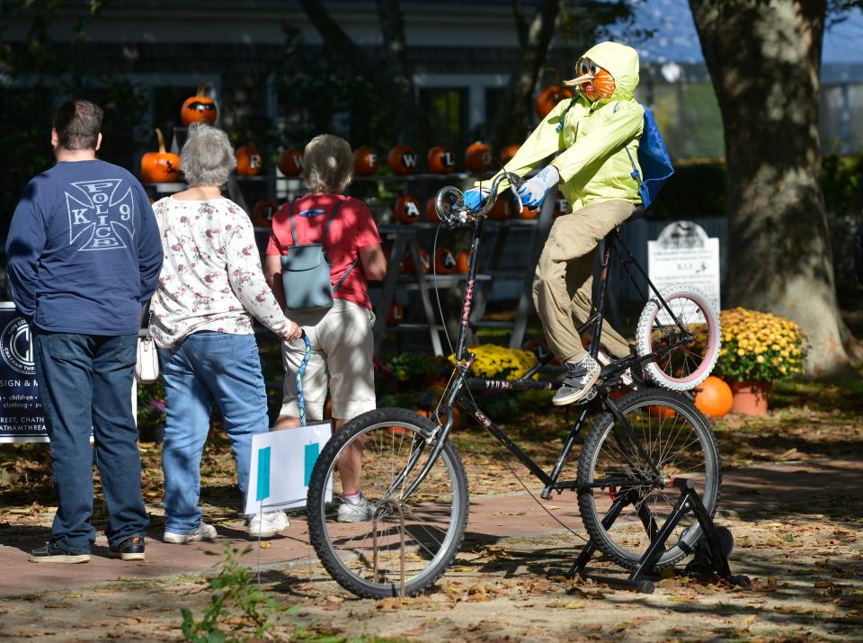 This member of the Pumpkin People in the Park in Chatham has a bicycle to ride courtesy of the Wheelhouse Bike Co. The displays are put together by local businesses and the event is sponsored by the Chatham Chamber of Commerce and Merchants Association.