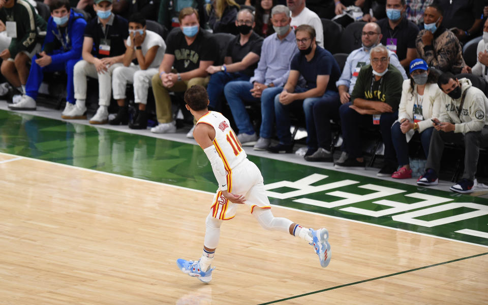 MILWAUKEE, WISCONSIN - JUNE 23: Trae Young #11 of the Atlanta Hawks celebrates a basket against the Milwaukee Bucks during the second quarter in game one of the Eastern Conference Finals at Fiserv Forum on June 23, 2021 in Milwaukee, Wisconsin. (Photo by Patrick McDermott/Getty Images)