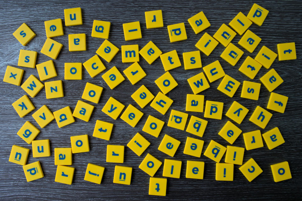 Blocks of English letters scattered. English alphabet letters spread out. Concept of confusion or difficulty in learning as in dyslexia.