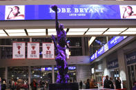 The Michael Jordan statue is illuminated in purple to honor Kobe Bryant before an NBA basketball game between the Chicago Bulls and the San Antonio Spurs Monday, Jan. 27, 2020, in Chicago. (AP Photo/David Banks)