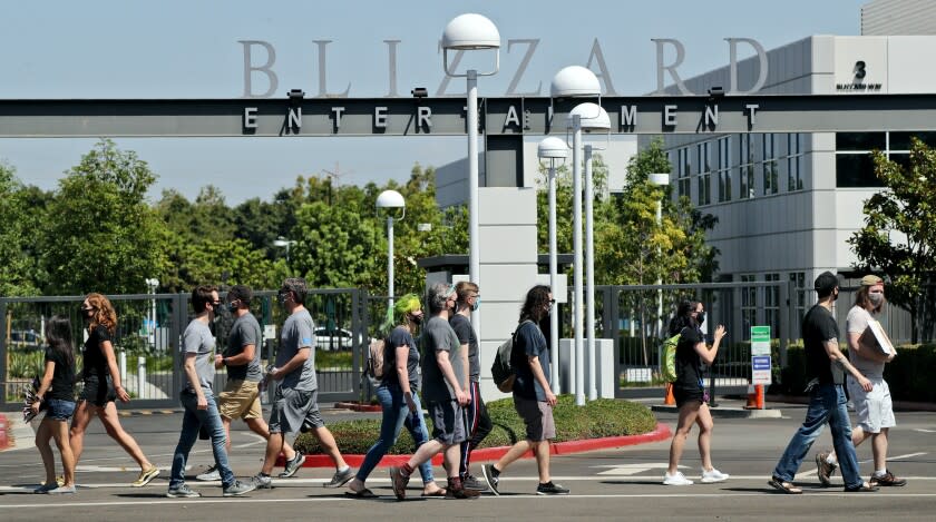 Employees pass in front of the main entrance during walkout to protest the reported sexual harassment and discrimination at Activision Blizzard, in Irvine on Wednesday, July 28, 2021. An organizer who did not want to give her name said that the walkout was "in solidarity with the victims who have stood up, who have made their voices heard. And we are looking to amplify those voices as well as to create a call to action on the demands that we listed." The company statement sent via email to this reporter by employee Christy Um said OWe are fully committed to fostering a safe, inclusive and rewarding environment for all of our employees around the world. We support their right to express their opinions and concerns in a safe and respectful manner, without fear of retaliation. The company does not retaliate for any such decision, should employees choose to participate or not. The company will not require employees to take time off to participate in this walkout.O The walkout began at 10am and continued until 2 pm. Nofurther actions were planned, according to walkout representatives.