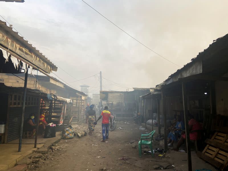 FILE PHOTO: Smoke rises over the neighboring houses after the fire tore through an overcrowded New-Bell central prison in the port city of Douala